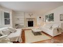 Cozy living room featuring a fireplace and built-in shelving at 133 Mine Ln, Boulder, CO 80302