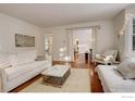 Bright and airy living room with white sofas and wood floors at 133 Mine Ln, Boulder, CO 80302