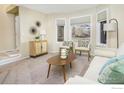 Bright living room featuring a comfy sofa and bay window at 1486 Clover Creek Dr, Longmont, CO 80503