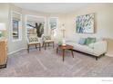 Bright living room featuring a comfy sofa and bay window at 1486 Clover Creek Dr, Longmont, CO 80503