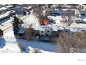 Aerial view of townhome complex with snow-covered yards at 1605 Longbow Ct, Lafayette, CO 80026