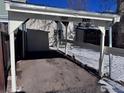 View of a carport with a wooden structure and a chain link fence at 1605 Longbow Ct, Lafayette, CO 80026