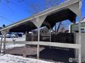 Carport with a sloped roof and chain link fence at 1605 Longbow Ct, Lafayette, CO 80026