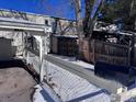 Side view of house showing exterior and fence in winter at 1605 Longbow Ct, Lafayette, CO 80026