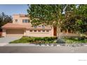 Tan stucco house with tile roof and attached garage at 1715 Sunset Blvd, Boulder, CO 80304