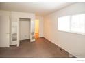 Simple bedroom with mirrored closet and private bathroom at 209 Lucerne Way, Lafayette, CO 80026