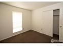 Bright bedroom with window, closet, and brown carpet at 209 Lucerne Way, Lafayette, CO 80026