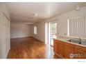 Kitchen features light wood cabinets and stainless steel sink at 209 Lucerne Way, Lafayette, CO 80026