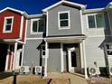 Gray and red townhomes with a shared walkway at 2150 Violet Ave, Boulder, CO 80304