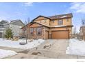 Two-story house with tan siding, brown accents, and a three-car garage, basketball hoop at 2262 Madison Dr, Erie, CO 80516