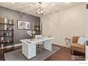 Modern home office with marble desk, gold shelving, and comfy chair at 2262 Madison Dr, Erie, CO 80516