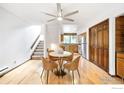 Dining area with a round table and four brown chairs near the kitchen and stairs at 2725 Juniper Ave # 78, Boulder, CO 80304