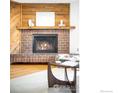 Brick fireplace with wood mantel, a focal point in the living room at 2725 Juniper Ave # 78, Boulder, CO 80304