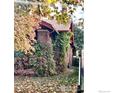 Brick home with ivy covered side elevation at 3139 Benton St, Wheat Ridge, CO 80214