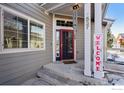 Inviting front entrance with a red door and a welcome sign at 3537 W 125Th Cir, Broomfield, CO 80020