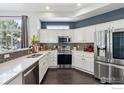 Modern kitchen with white cabinets, stainless steel appliances, and quartz countertops at 3537 W 125Th Cir, Broomfield, CO 80020