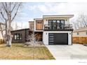 Contemporary two-story home with a balcony, modern garage door, and manicured lawn at 3560 16Th St, Boulder, CO 80304