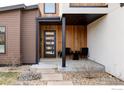 Inviting front porch with seating area, modern front door, and stylish wood accents at 3560 16Th St, Boulder, CO 80304