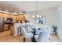 Bright dining area showcasing hardwood floors, stylish lighting, and modern decor near the kitchen at 4137 Clifton Ct # C, Boulder, CO 80301