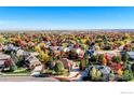 Beautiful aerial shot of the neighborhood with mature trees and colorful fall foliage at 449 Meadow View Pkwy, Erie, CO 80516