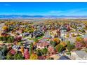 Stunning aerial view of the property nestled in a colorful neighborhood with mountain views at 449 Meadow View Pkwy, Erie, CO 80516