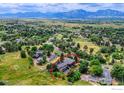 Aerial view of the property showcasing a modern home with a two-car garage and vast mountain views at 512 Ponderosa Dr, Boulder, CO 80303