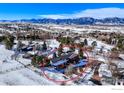 Property showcasing a modern home surrounded by a winter landscape and mountains at 512 Ponderosa Dr, Boulder, CO 80303