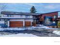 Contemporary home with attached three-car garage and snow covered driveway at 512 Ponderosa Dr, Boulder, CO 80303