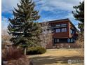 Luxury home with wood and stone accents, nestled in a snowy landscape at 512 Ponderosa Dr, Boulder, CO 80303