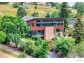 Contemporary home surrounded by lush landscaping and mature trees for a private, natural setting at 512 Ponderosa Dr, Boulder, CO 80303