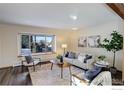 Living room with a large window, hardwood floors, and neutral-toned furniture at 5375 Gunbarrel Cir, Longmont, CO 80503