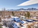 Aerial view of houses with mountain backdrop in snowy landscape at 5526 Friends Pl, Boulder, CO 80303