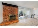 Brick fireplace with glass doors and a tiled hearth at 805 29Th St # 252, Boulder, CO 80303