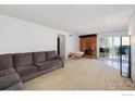 Living room with fireplace, sliding glass doors to balcony, and large windows at 805 29Th St # 252, Boulder, CO 80303