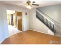 Living room with wood floors and staircase to upper level at 8266 Washington St # 82, Denver, CO 80229