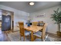 Charming dining area with wood table and four chairs at 8267 Quay Ct, Arvada, CO 80003