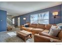 Spacious living room with leather sectional sofa and wood coffee table at 8267 Quay Ct, Arvada, CO 80003