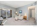 Living room with a sofa, carpet, and sliding glass doors at 1138 Opal St # 101, Broomfield, CO 80020