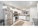 Modern kitchen with stainless steel appliances and dark countertops at 11661 Kearney Way, Thornton, CO 80233