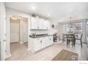 Open concept kitchen with white cabinets and a breakfast nook at 11661 Kearney Way, Thornton, CO 80233