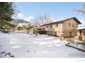 Spacious backyard with a deck and mountain views in winter at 1382 Glen Ct, Boulder, CO 80305