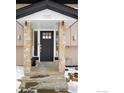 Modern front entrance with stone pillars and a dark-colored door at 1382 Glen Ct, Boulder, CO 80305