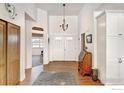 Bright entryway with hardwood floors, chandelier, and built-in desk at 1393 Sara Lynn Ln, Berthoud, CO 80513