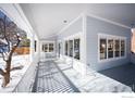 Spacious porch with white railings, overlooking snowy backyard at 1465 Periwinkle Dr, Boulder, CO 80304