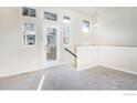 Bright and airy living room with carpeted floors and access to a patio at 1580 Venice Ln, Longmont, CO 80503