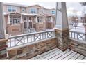 View from a porch, overlooking a snow-covered townhome community at 1580 Venice Ln, Longmont, CO 80503