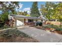 Brick ranch house with pumpkins and a spacious yard at 1855 Grape Ave, Boulder, CO 80304