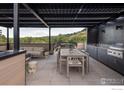 Outdoor kitchen, dining area, and seating on a rooftop deck with mountain views at 1955 3Rd St # 6, Boulder, CO 80302