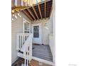 Front door entry with deck and stairs leading up to the condo at 2141 Sunridge Cir, Broomfield, CO 80020