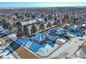 Aerial view of a suburban neighborhood with houses and snowy streets at 241 Sherwood Ct, Longmont, CO 80504